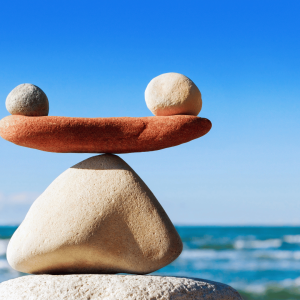 2 stones balancing on another stone